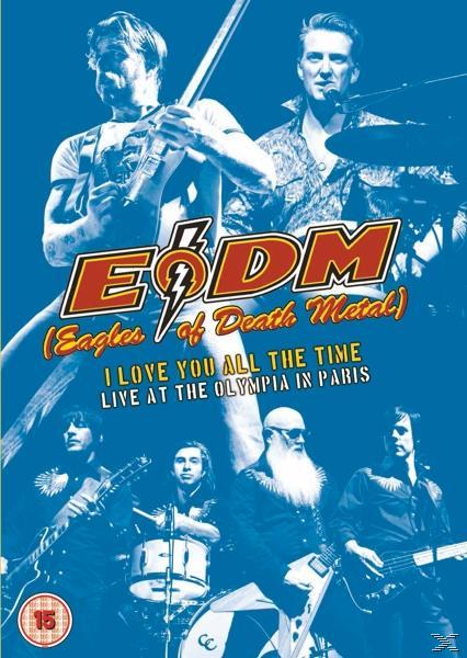 Poster voor 'EODM Live at the Olympia in Parijs'. Toont bandleden, rood en wit logo en tekst op een blauwe achtergrond.