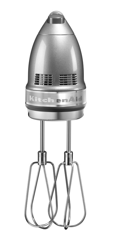 A silver KitchenAid hand mixer. It has two beaters and sits against a white background.
