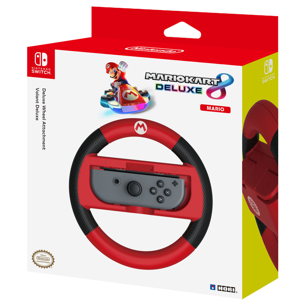Mario Kart Deluxe 8 Lenkradaufsatz in der Box. Rotes Lenkrad mit schwarzen Griffen und einem grauen Schalter.