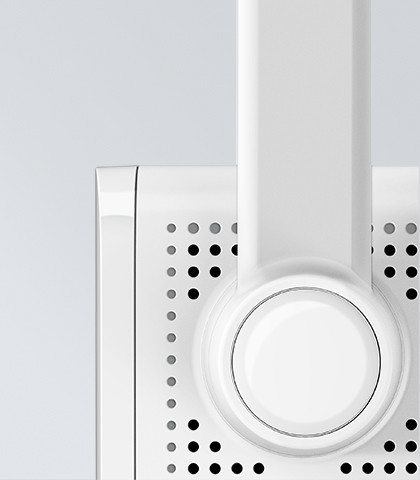 White appliance detail, close-up. Features a circular design with many small holes.