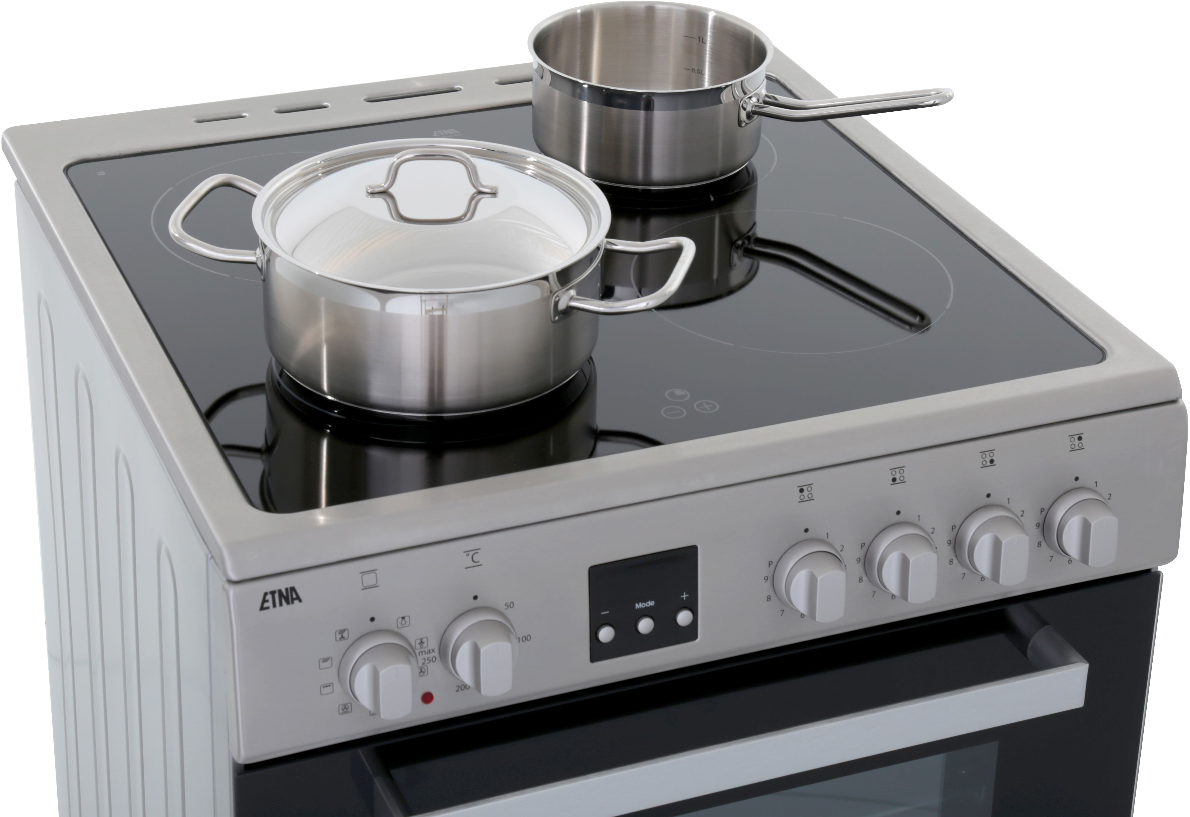 A silver stove top with two pots on it, and control knobs. The oven part is visible below the stove.
