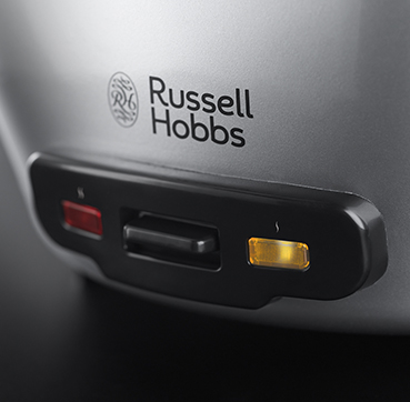 A grey Russell Hobbs appliance with a black panel and red and yellow lights.