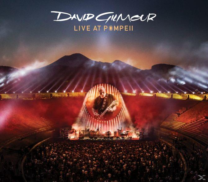 Albumhoes van David Gilmour Live at Pompeii. Opstelling van het podium met publiek en een muzikant op het podium.