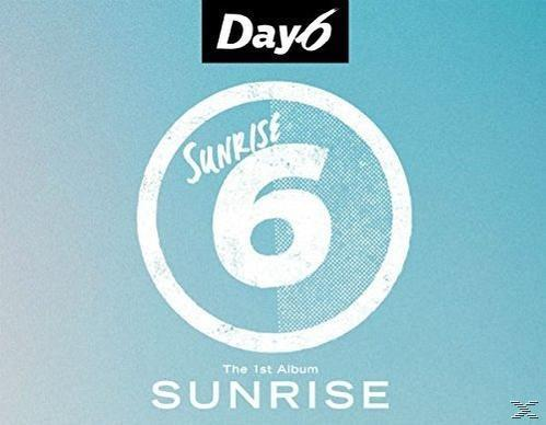 Albumhoes met de bandnaam "Day6" en de albumtitel "Sunrise". Blauwe achtergrond.