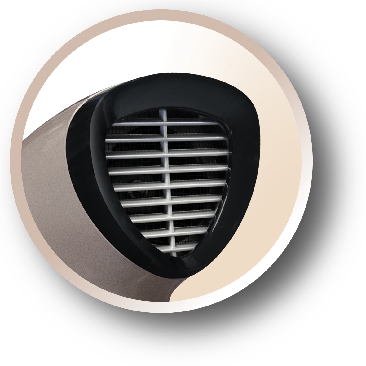 Close-up of a hair dryer's air intake, with a metallic gold finish and black detailing within a circular frame.