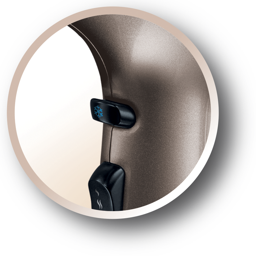 Close-up of a hair dryer. A cold air button is visible.