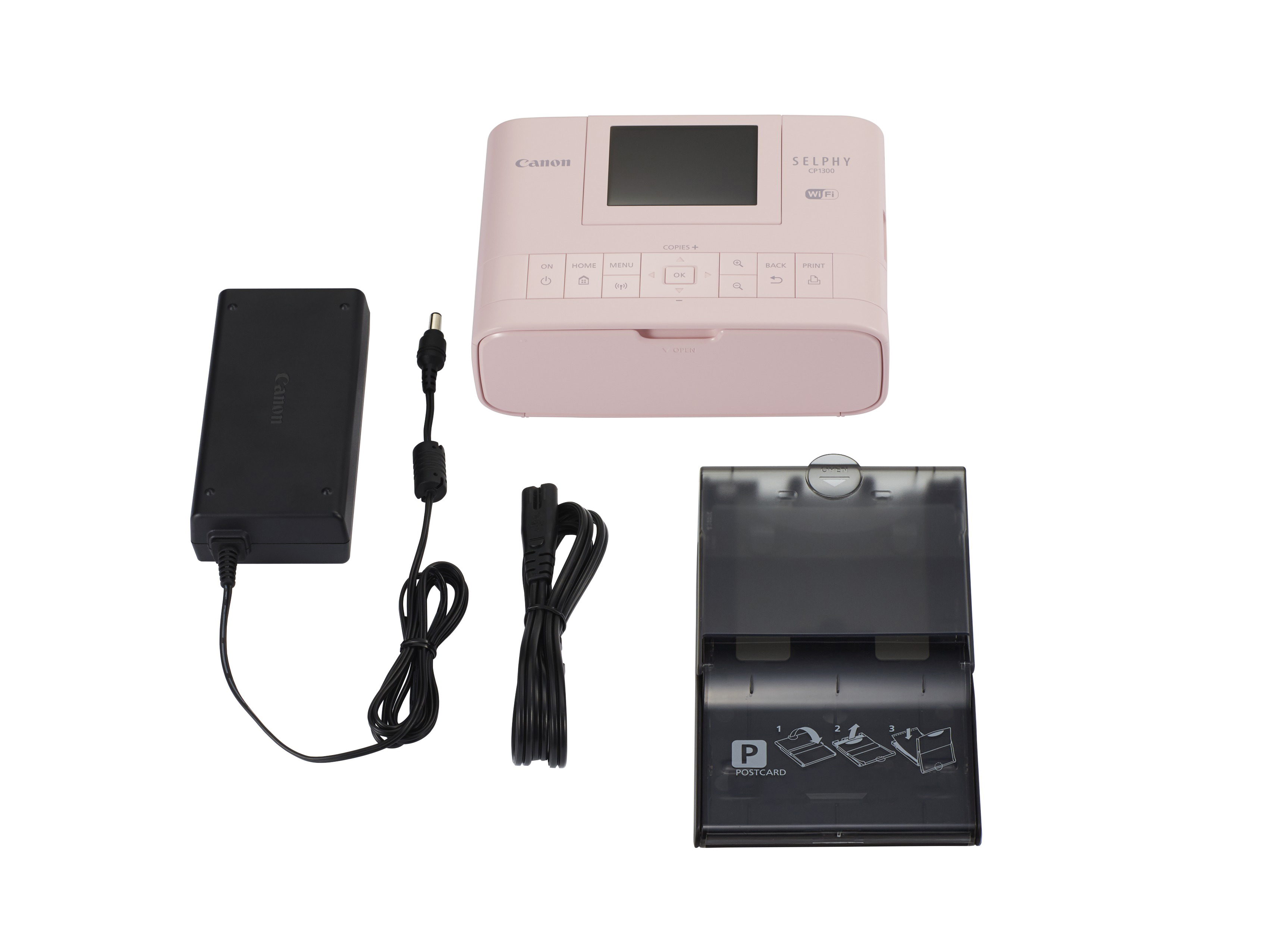 Pinker Canon Selphy Fotodrucker mit Netzteil, Kabel und Papierfach. Der Drucker hat einen Bildschirm.