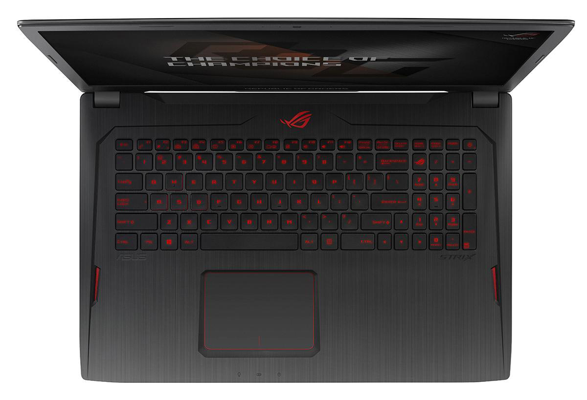 Draufsicht auf einen ASUS ROG Gaming-Laptop mit rot beleuchteter Tastatur.