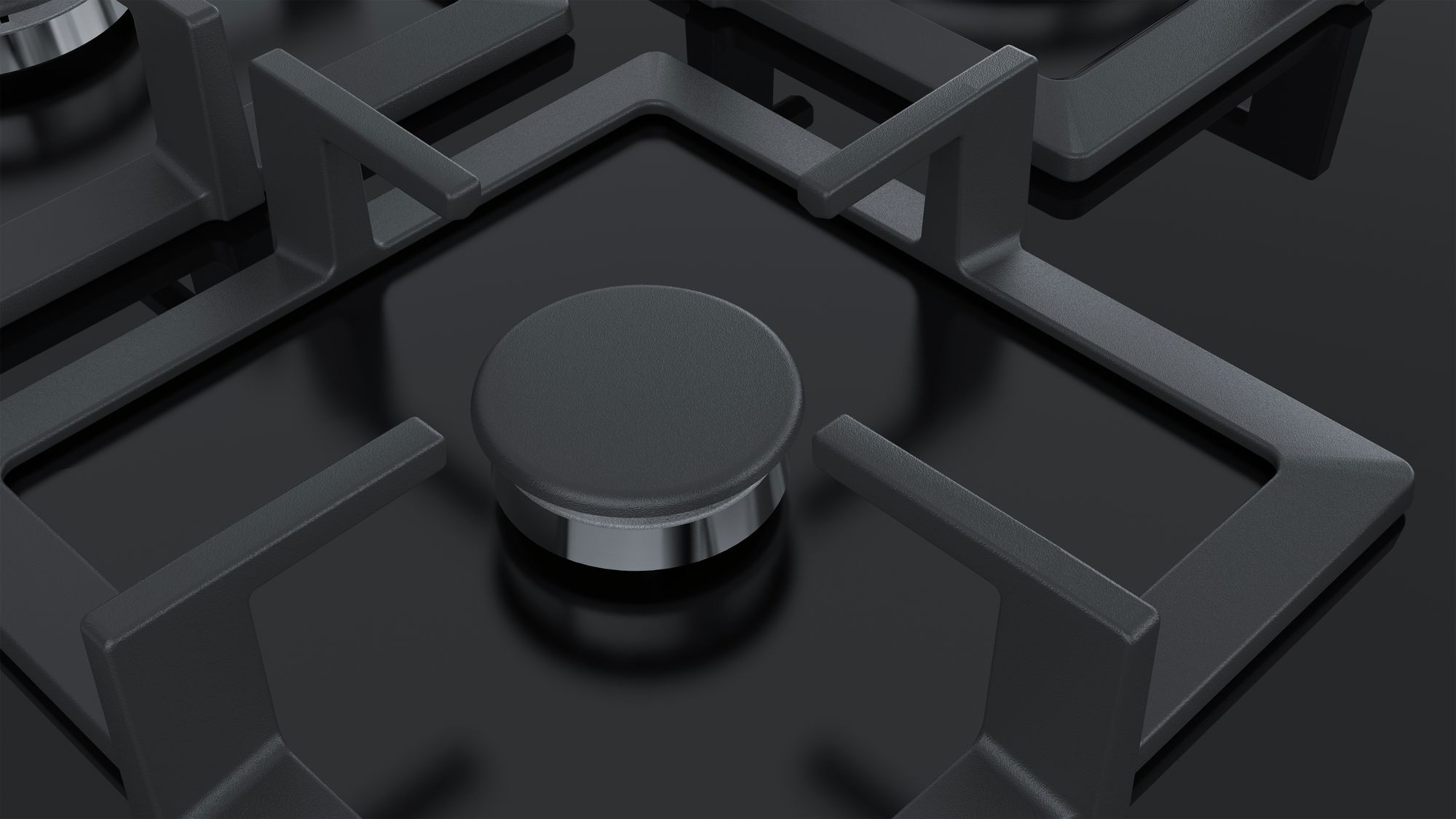 Close-up of a black gas stove with four grates and a central knob.
