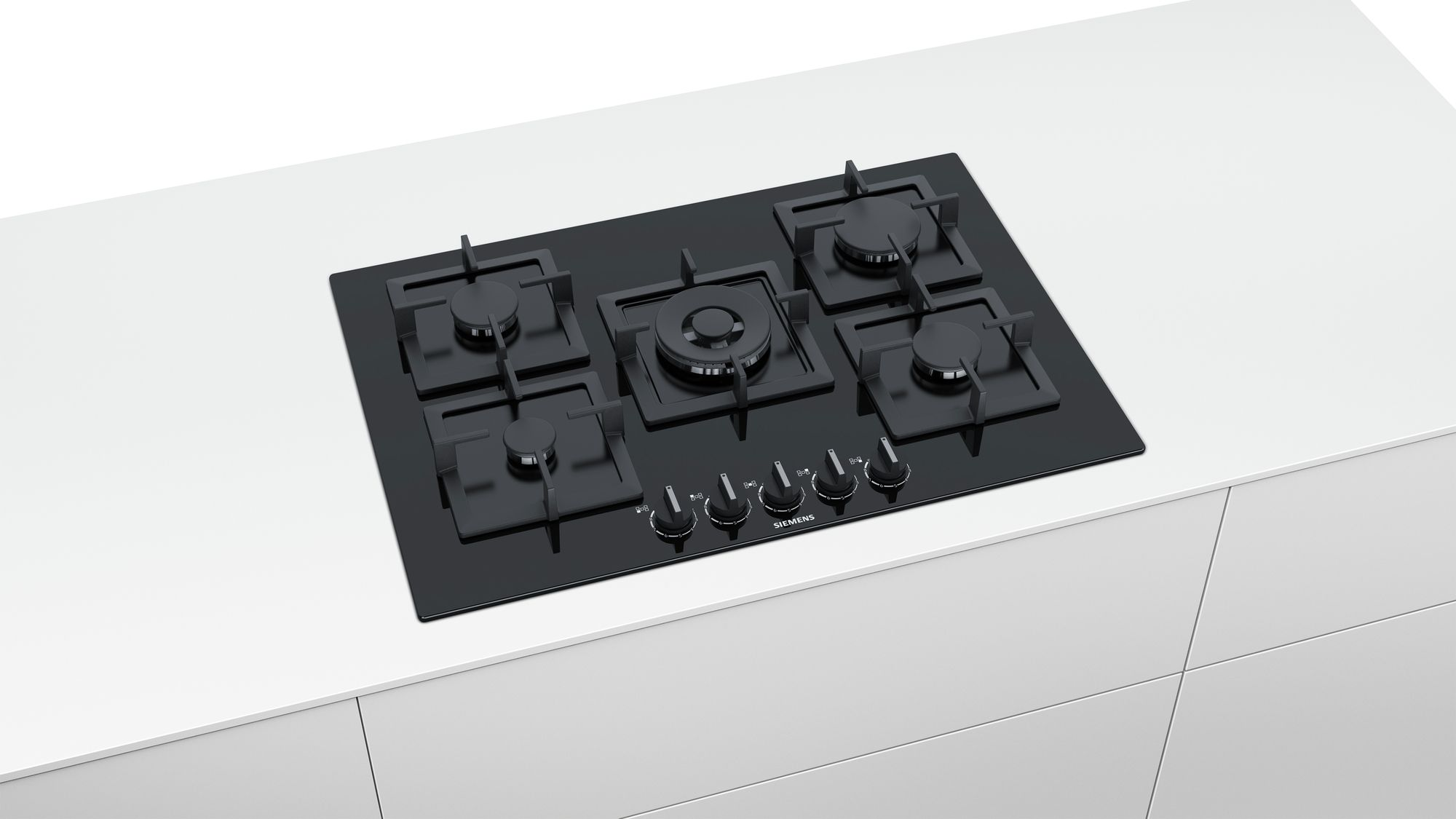 Black gas cooktop with five burners. Knobs are visible, white countertop.