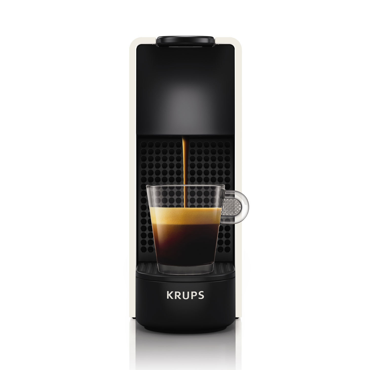 Creme- und schwarze Nespresso-Maschine. Kaffee fließt in eine Glastasse.