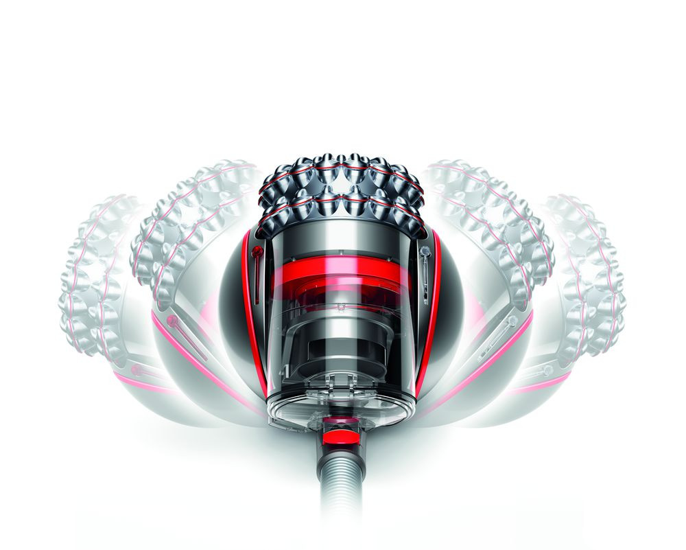 Dyson vacuum cleaner in motion. The ball-shaped body rotates with the red section visible. White background.