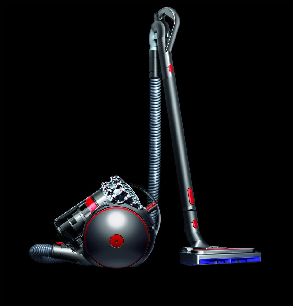 A black Dyson vacuum cleaner. It has a red ball and a long, gray handle and hose.
