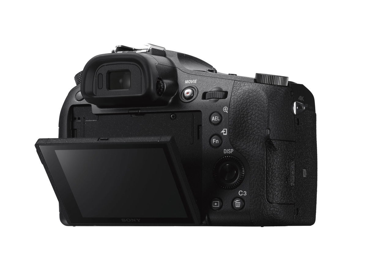 Fotocamera nera con schermo aperto. La parte posteriore della fotocamera è visibile, con pulsanti e ghiere.