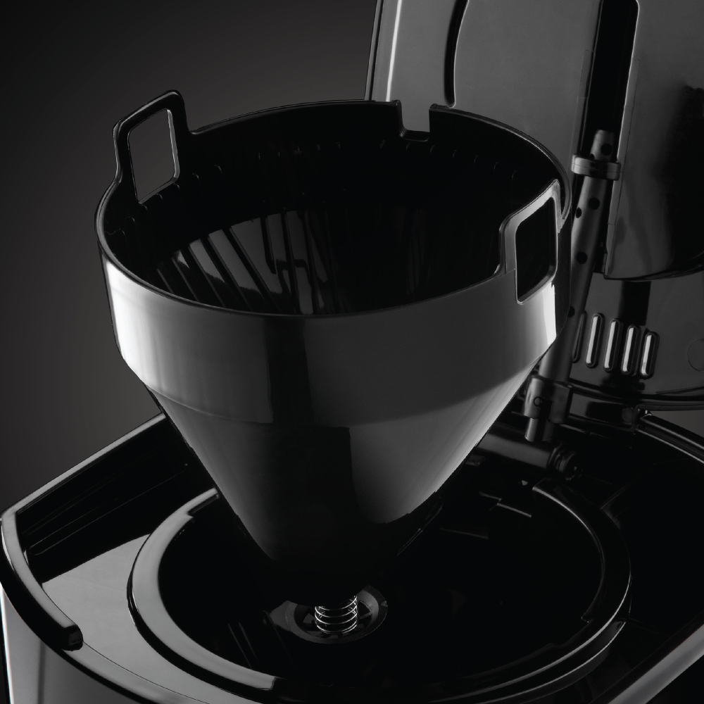 Close-up of a black coffee maker's filter basket and the brewing area.