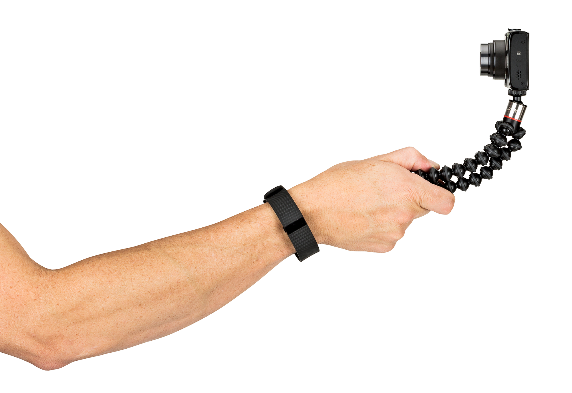 A hand holding a camera attached to a flexible tripod, with a smart wristband.