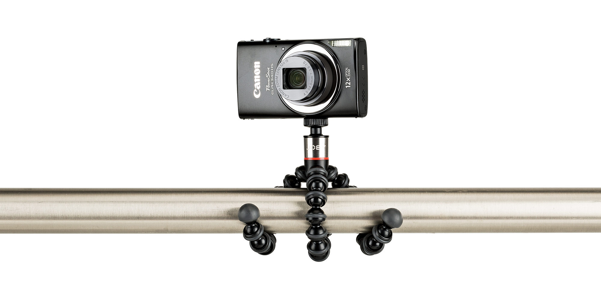 Camera on a flexible tripod. A black camera sits on a tripod attached to a silver pole.
