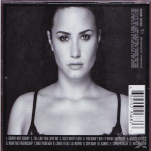 CD-hoes van Demi Lovato. Zwart-wit afbeelding van haar gezicht. Tekst bevat songtitels en een barcode.