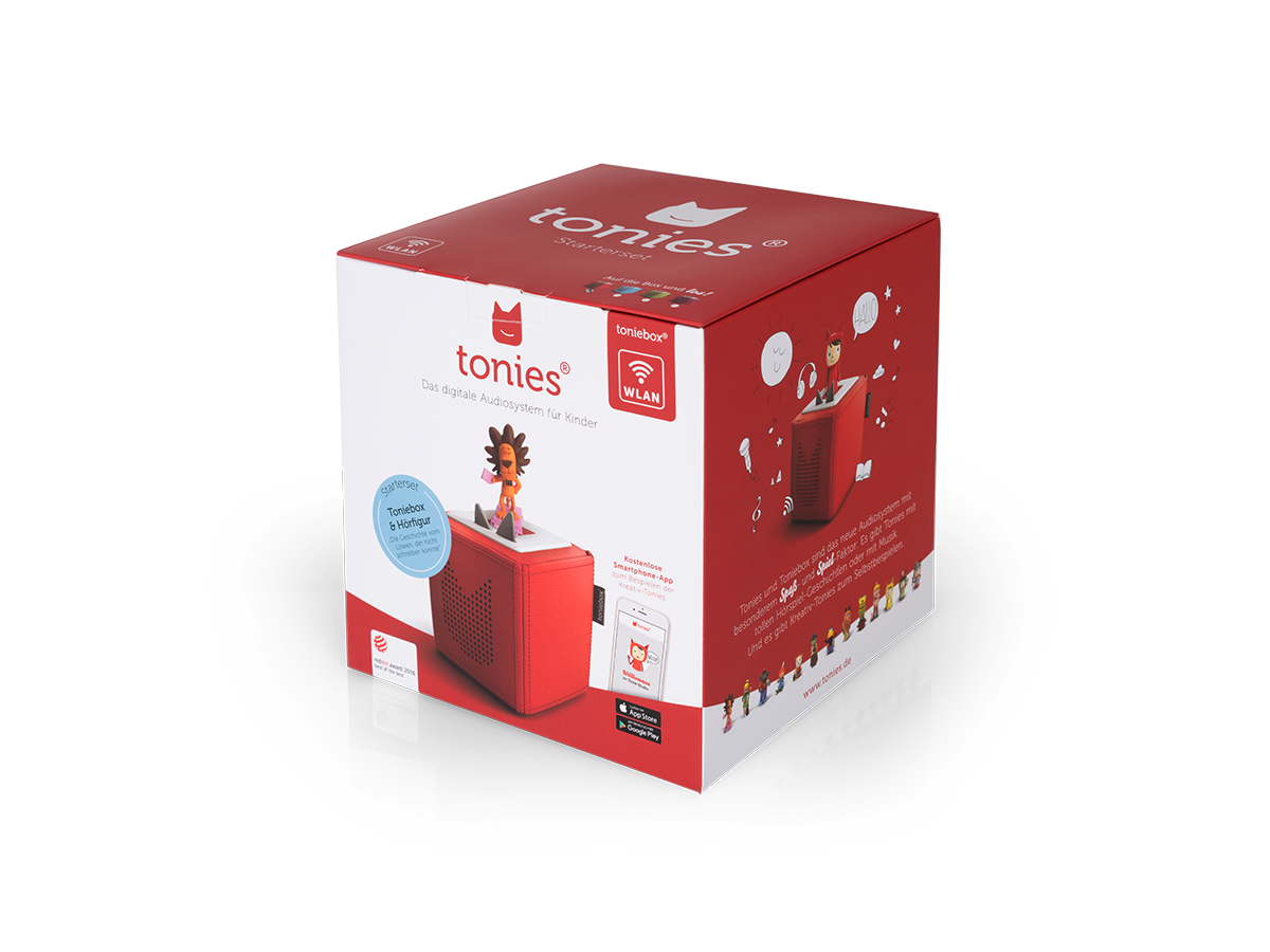Eine rote Toniebox steht auf einer weißen Box. Eine Figur steht auf der Box. Der Text lautet 'tonies' und 'Das digitale Audiosystem für Kinder'.
