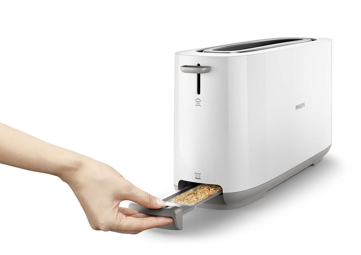 White toaster. Hand pulls a tray with bread. Philips logo. White background.