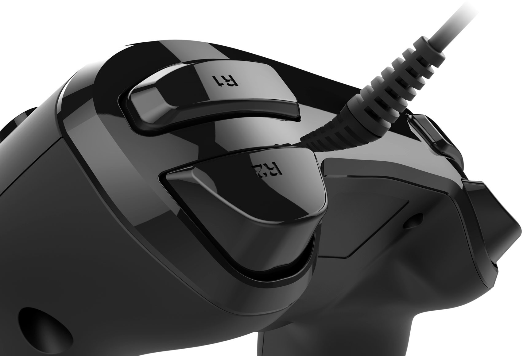 Close-up of a black game controller with buttons labeled R1 and R2, and a cable.