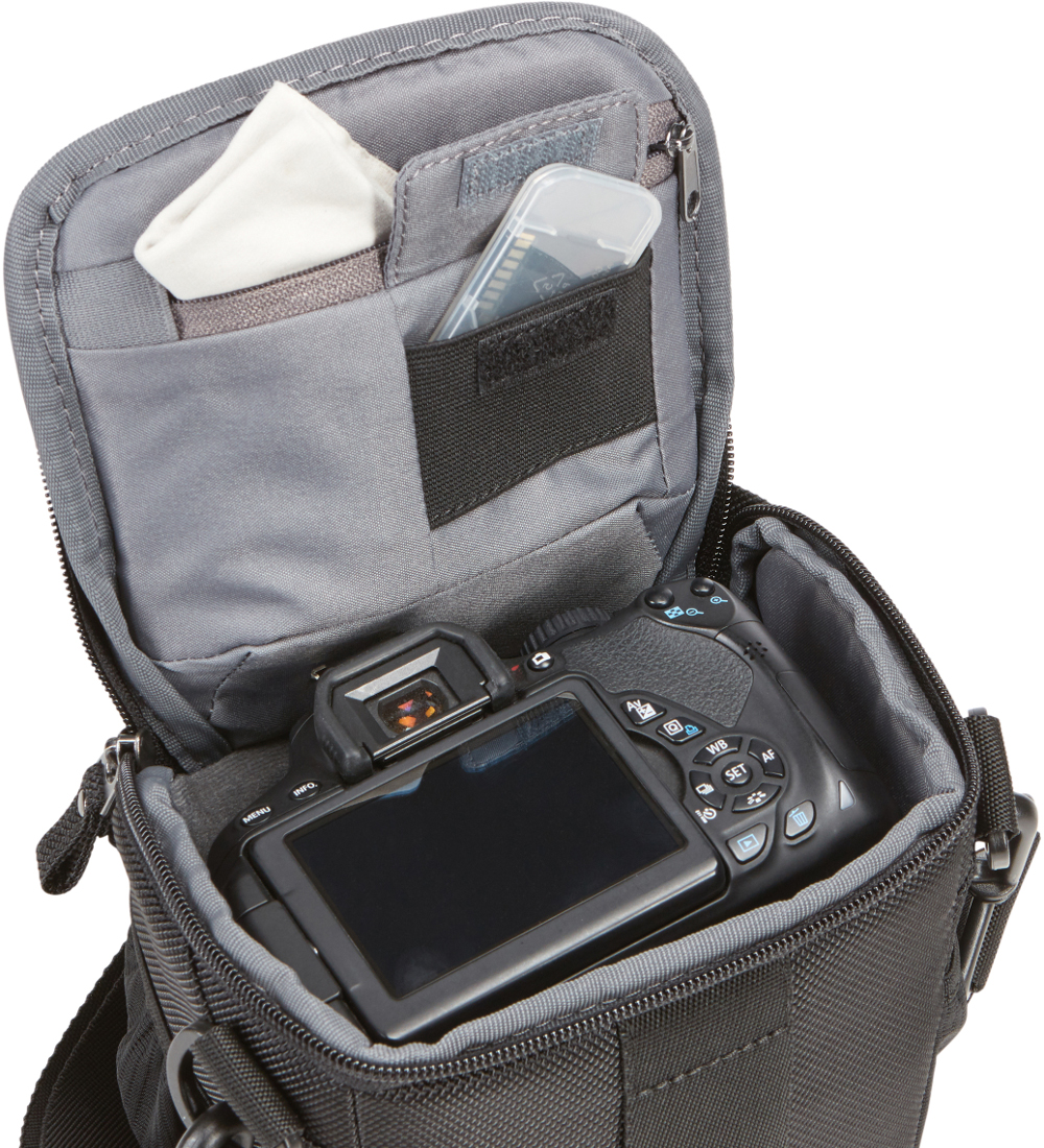 Camera bag open, with a camera, lens, and cleaning cloth inside. A memory card is in the top pocket.