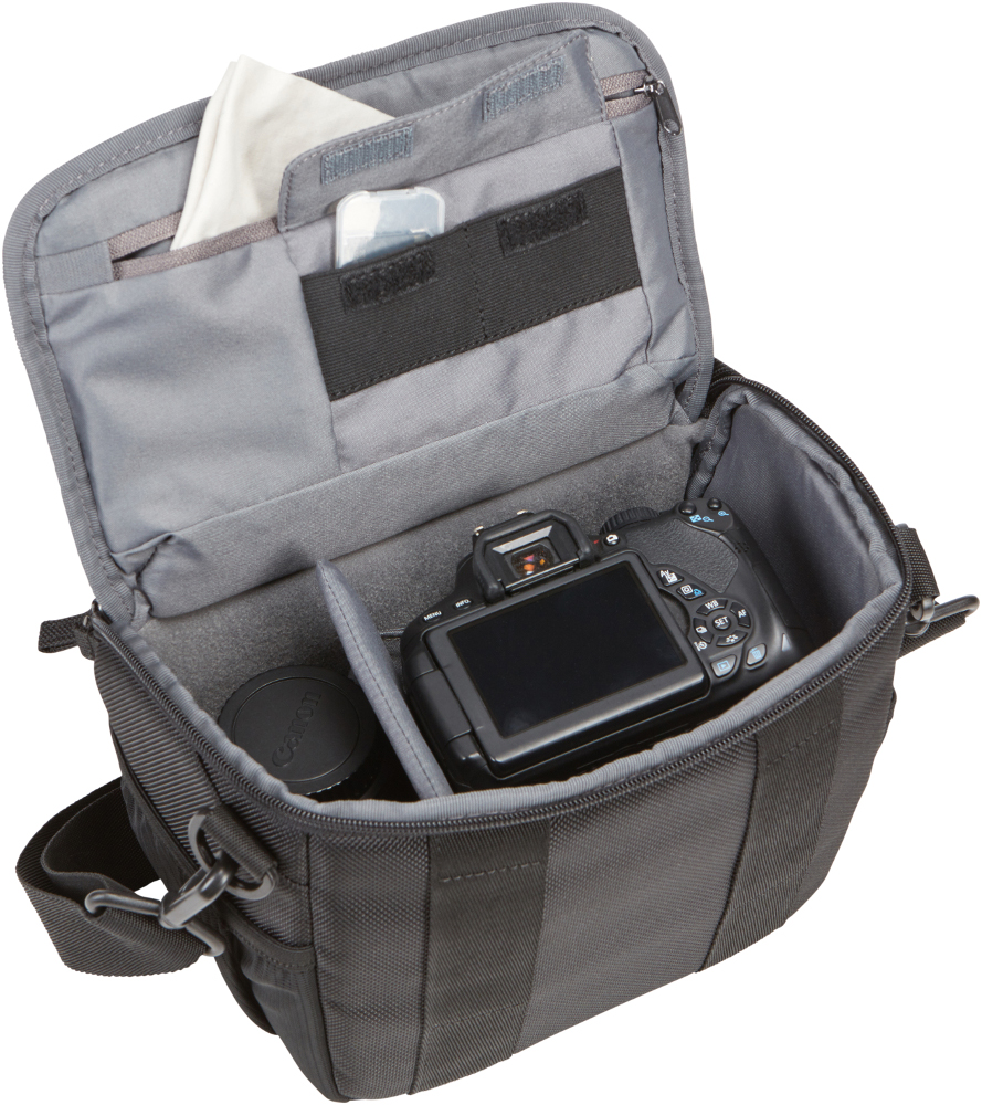 Camera bag open, with camera, lens, and a cleaning cloth inside. The bag is black.