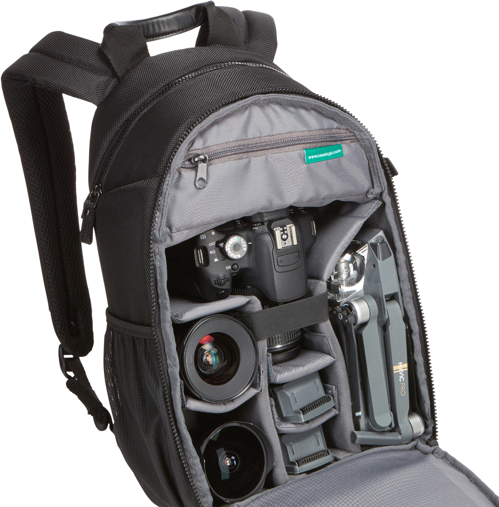 Black camera backpack, open. Contains cameras, lenses, and a drone. Gray interior.
