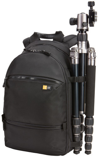 A black backpack with a tripod attached to it.