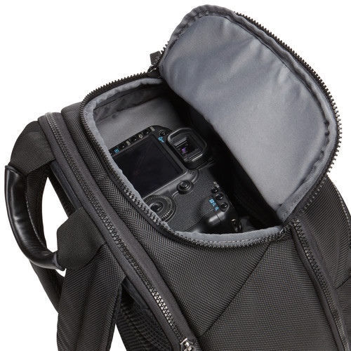 Black camera bag open. A camera is visible inside the bag.
