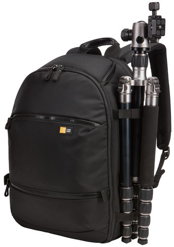 Black backpack with a tripod attached. It is on a white background. The tripod is black and silver.