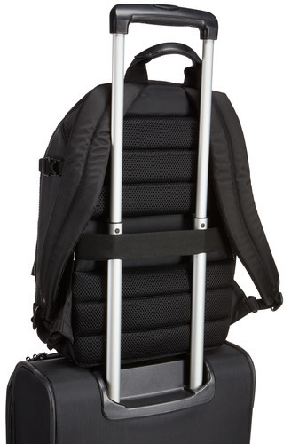 Black backpack on top of a suitcase, with the handle extended.