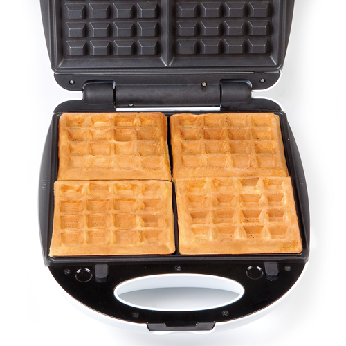 Waffle maker with four golden brown waffles. It's open on a white background.