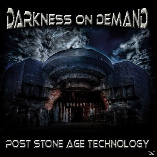 Albumcover 'DARKNESS ON DEMAND', ein Betonbunker unter einem dunklen, stürmischen Himmel mit 'POST STONE AGE TECHNOLOGY'.