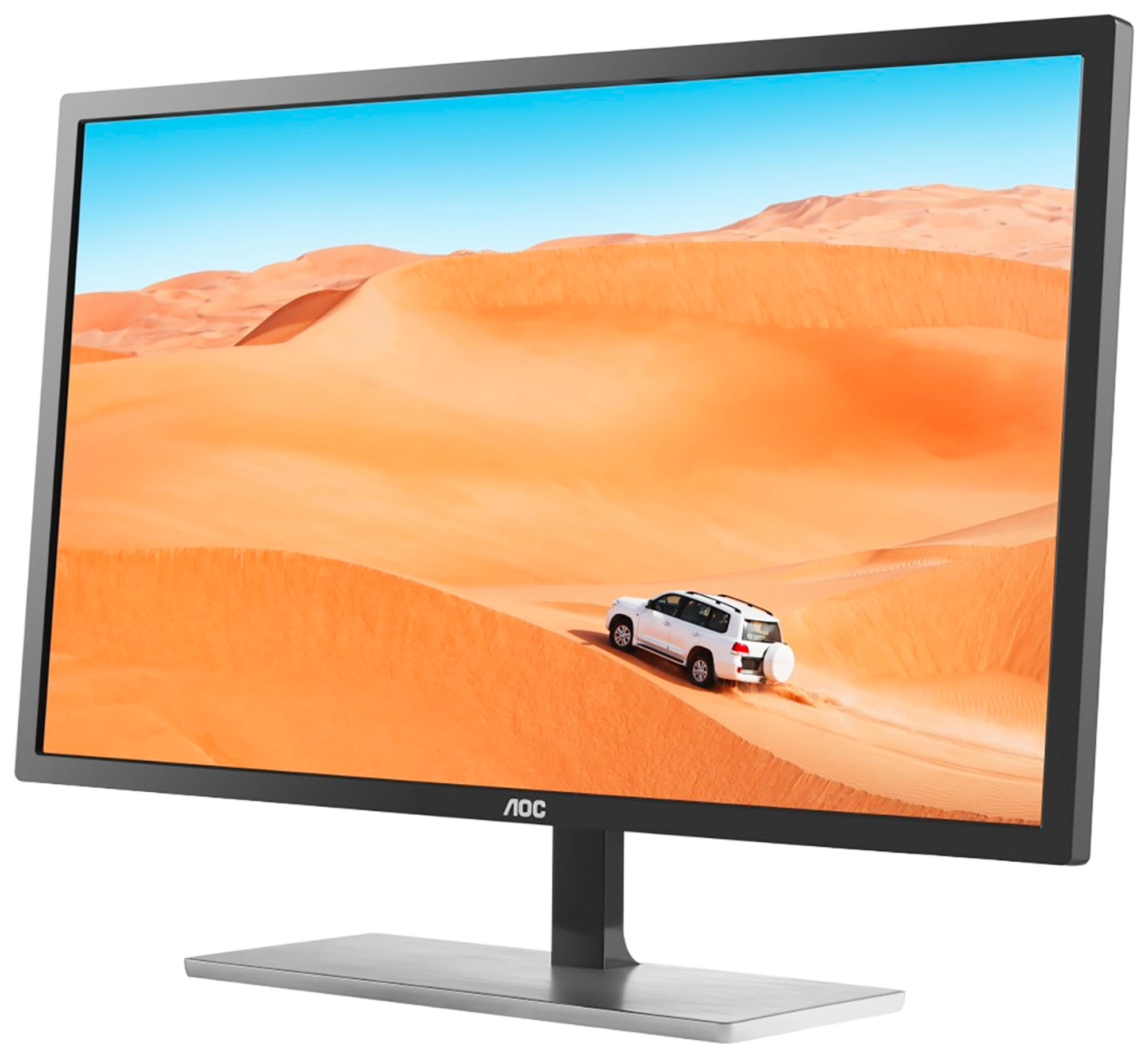 Un monitor de computadora muestra una escena del desierto con un coche blanco. El monitor tiene marco negro.