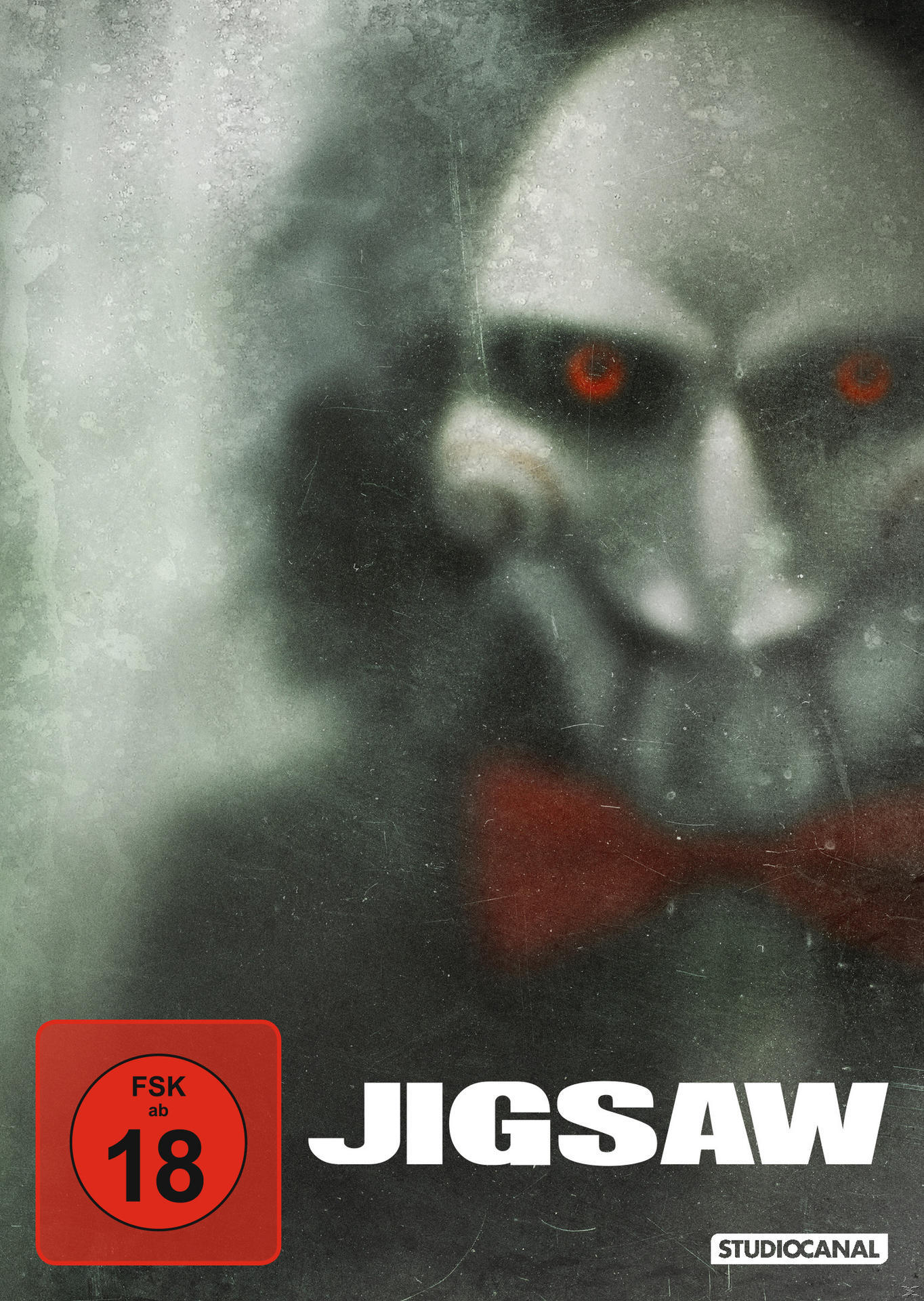 Jigsaw-Filmplakat mit einem gruseligen Gesicht und roter Fliege.