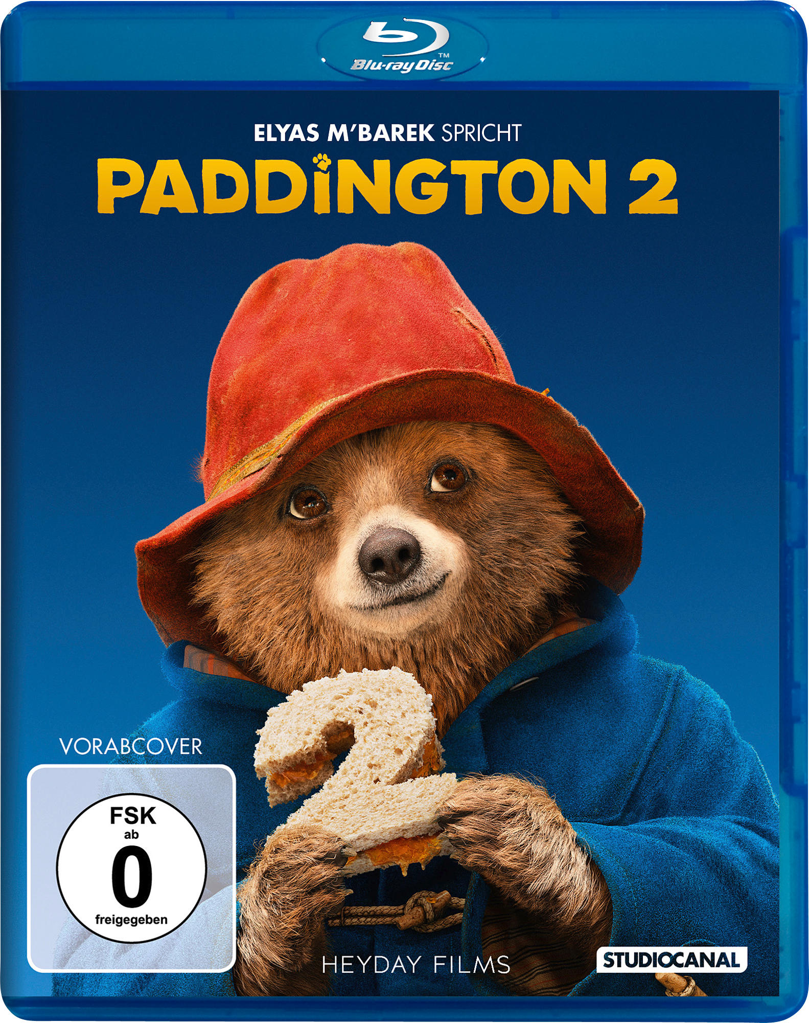 Paddington 2 Blu-ray-Cover: Bär mit Sandwich, Text und blauem Hintergrund.