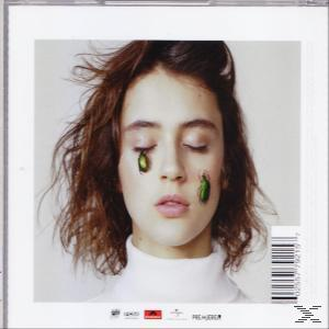 Pochette d'album d'une femme avec des autocollants verts en forme de scarabée sur le visage.