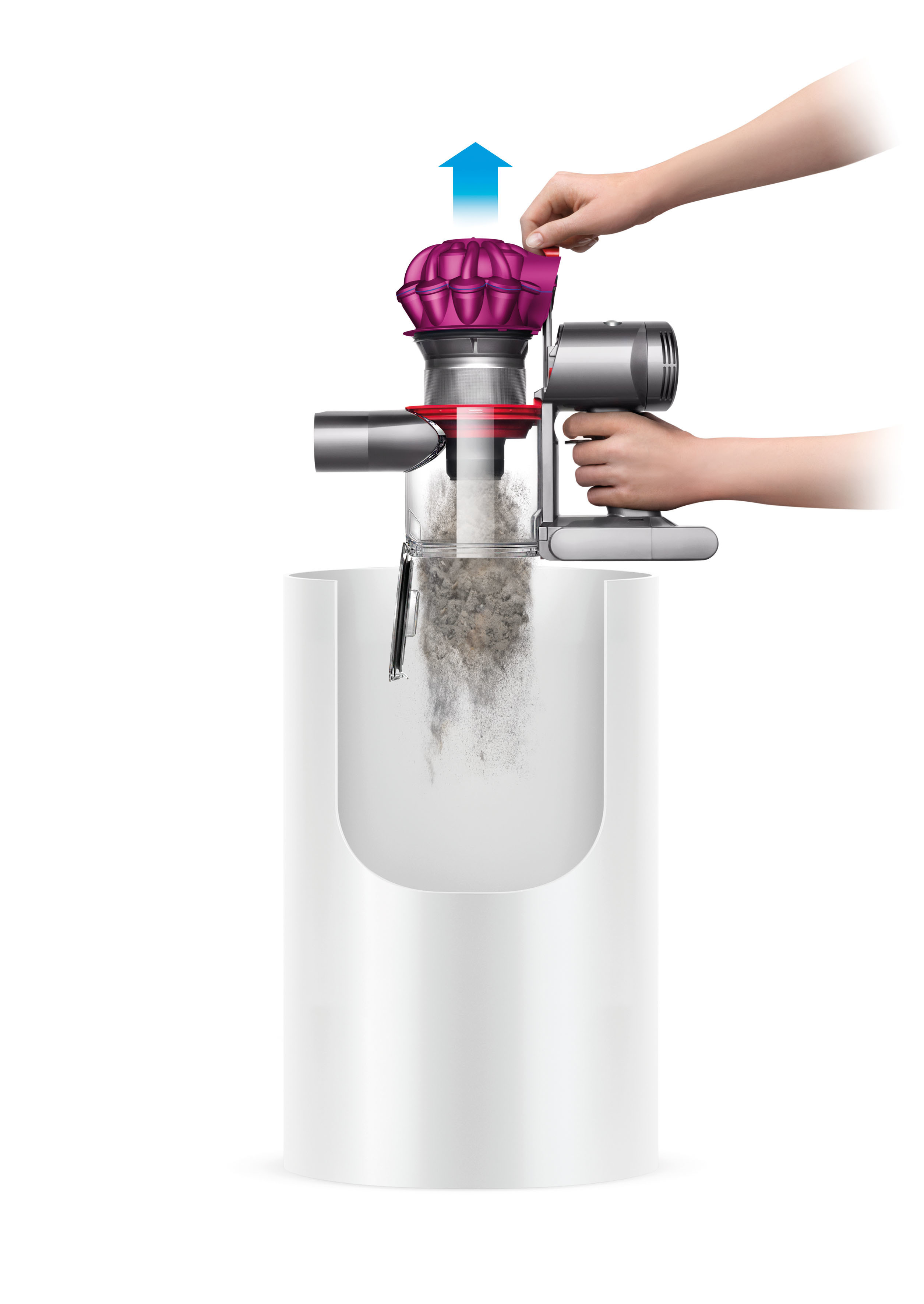 Ein Dyson-Staubsauger wird in einen weißen Behälter entleert. Staub fällt aus dem Kanister.