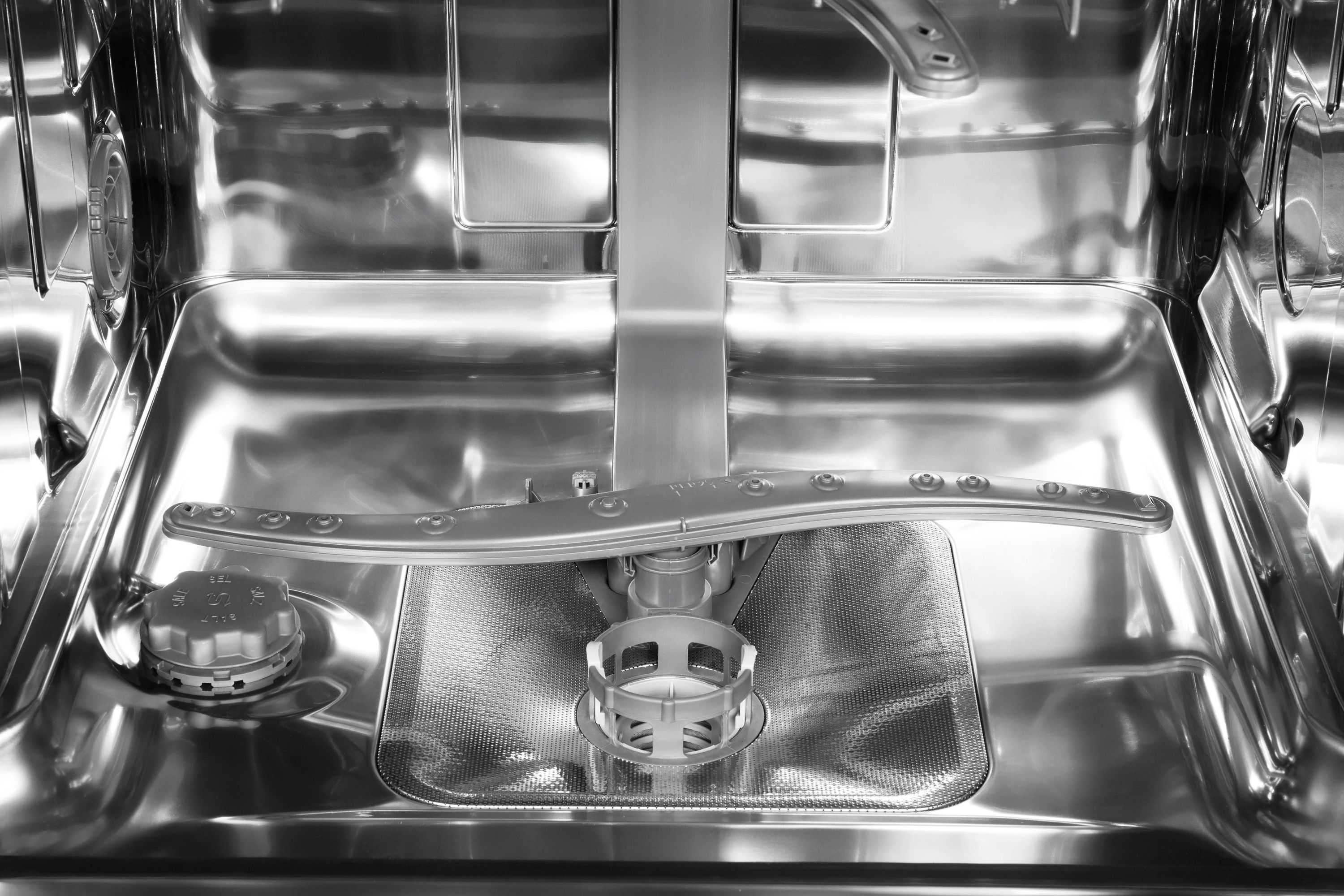 Inside a stainless steel dishwasher, spray arms and filter are visible.