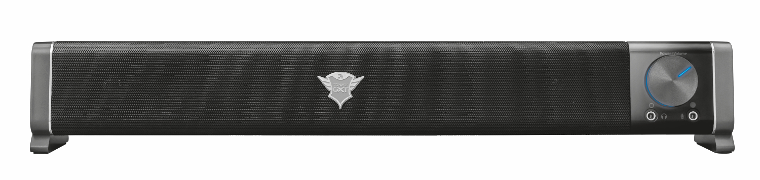 Barre de son noire avec façade en maille, détails argentés et molette de volume. Le logo Trust est centré.