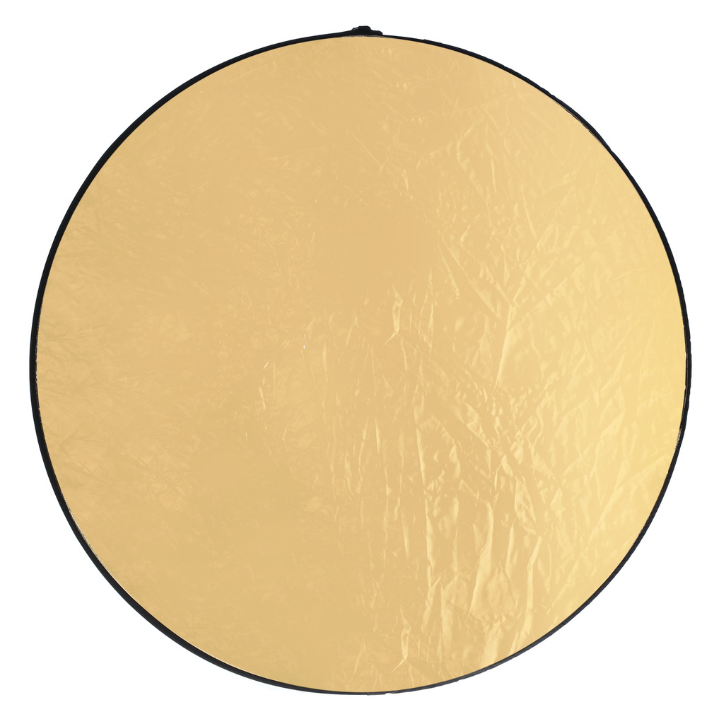 A gold, circular reflector. Black trim around the edge. Wrinkled surface reflects light.