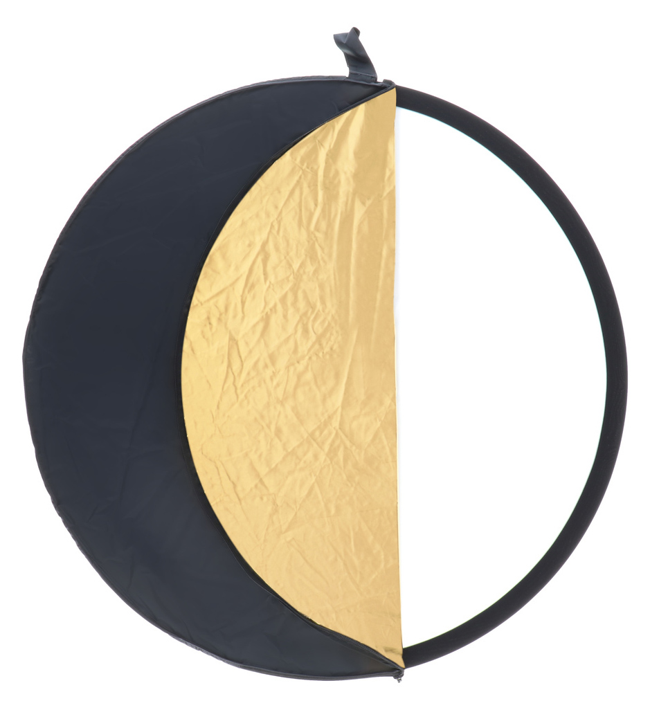 A circular photography reflector with a black frame. Half is gold, and the other half is white.