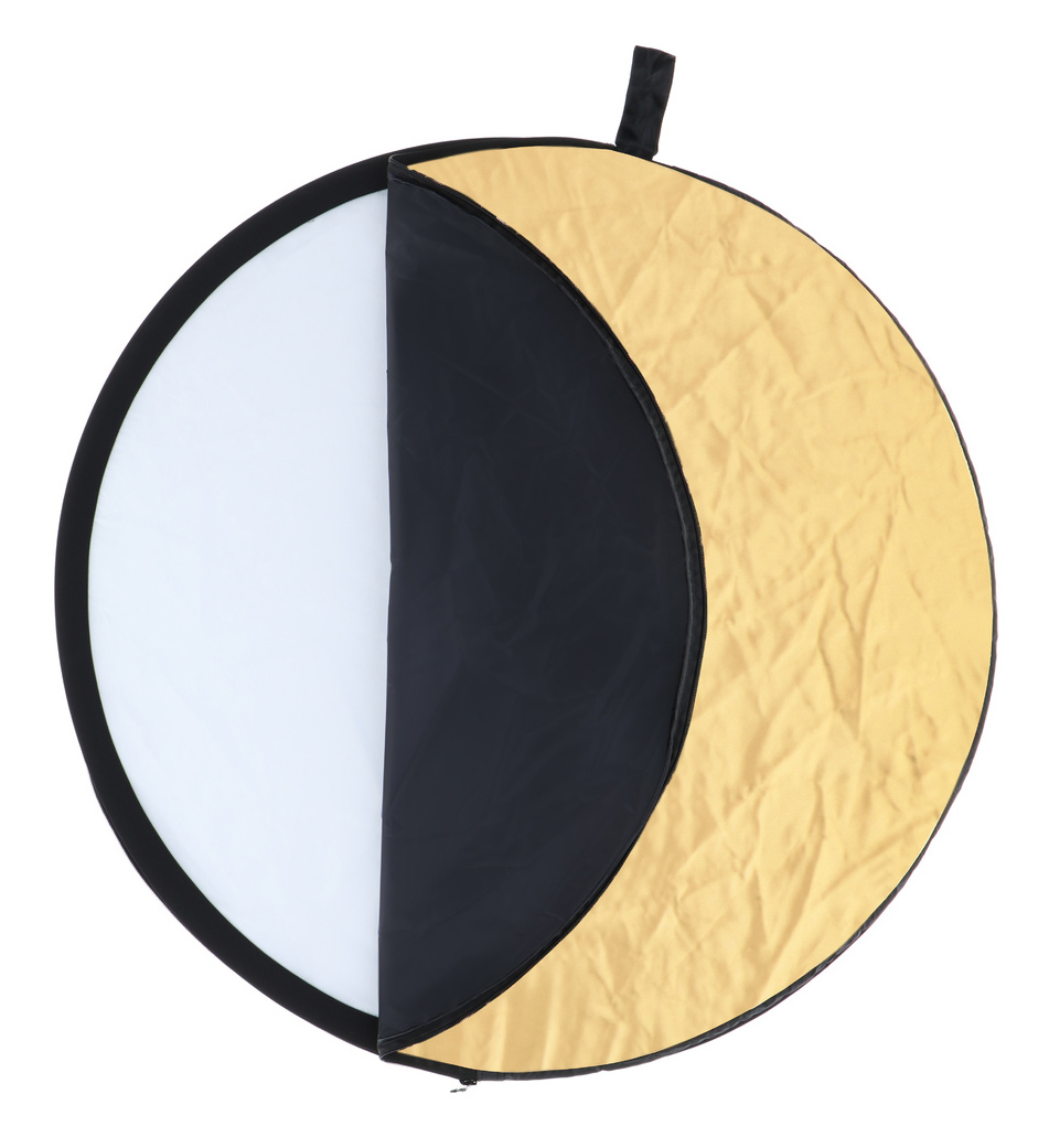 A round reflector, half white and half gold, with a black frame. Used for photography.