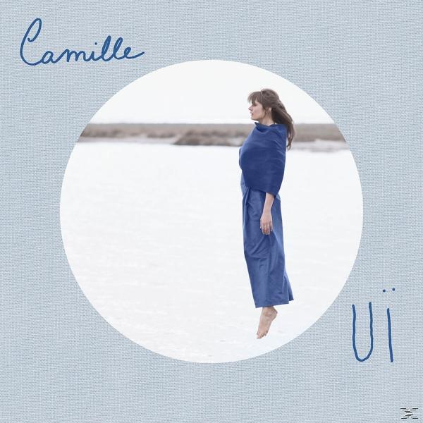 Albumhoes met een vrouw in blauwe kleding, zwevend. Titel: Camille, met tekst in een cirkel.