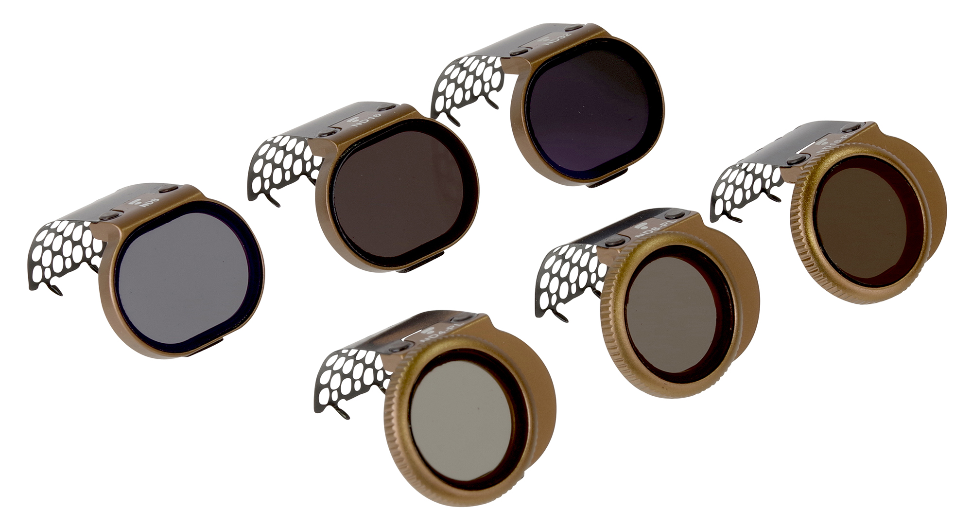 Zes cameralensfilters. Elk heeft een gouden ring, een donker filter en een zwarte cover met een uniek snijpatroon.