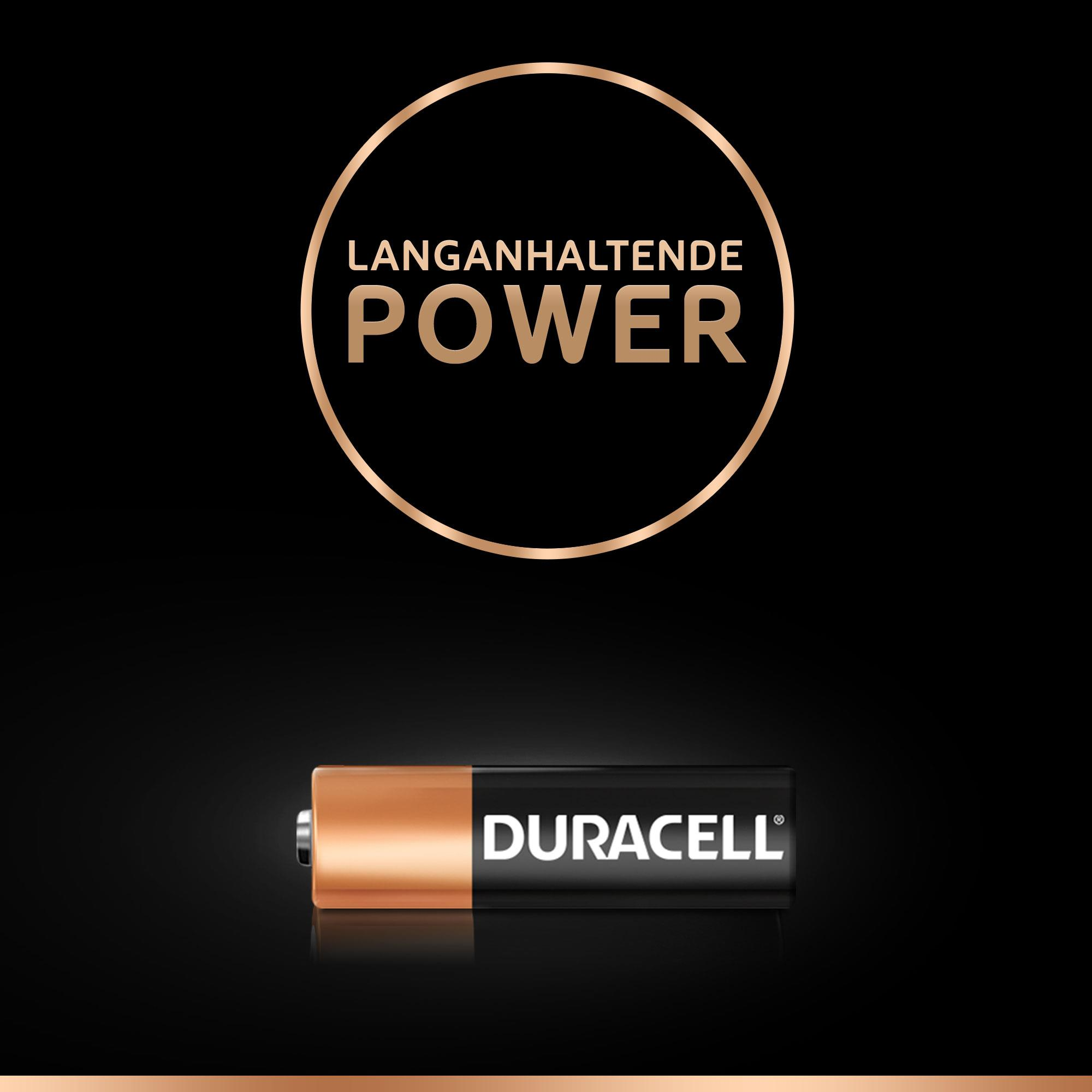 Pila Duracell con parte superiore in rame e corpo nero, testo "DURACELL", su sfondo nero.