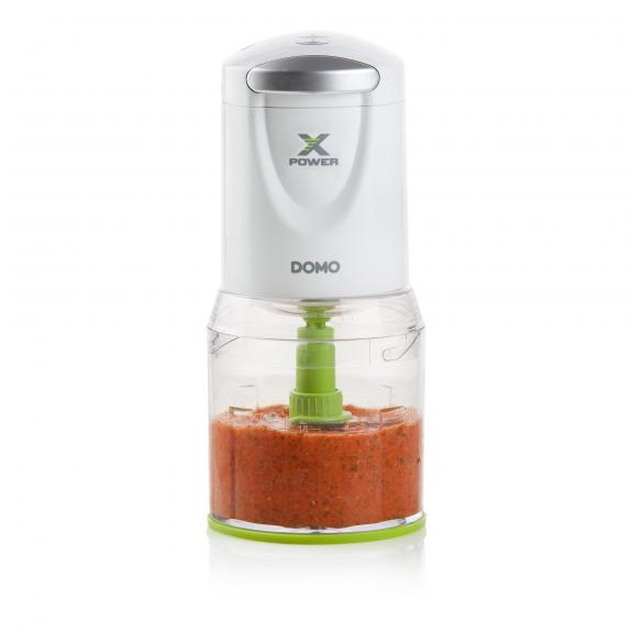Robot culinaire blanc et vert avec de la nourriture rouge. L'appareil est propre.