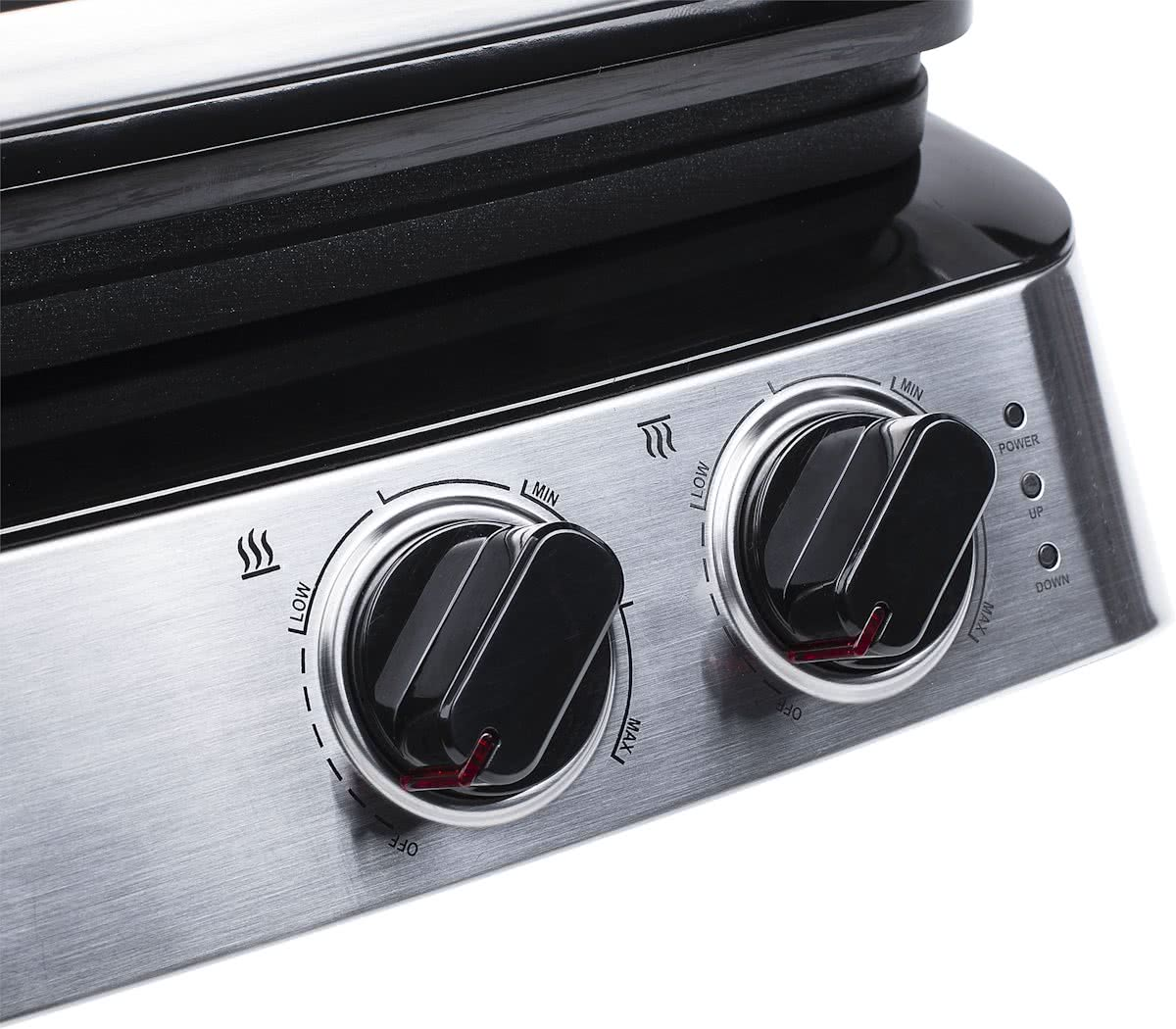 Close-up of a grill's control panel with two black knobs, showing heat settings.