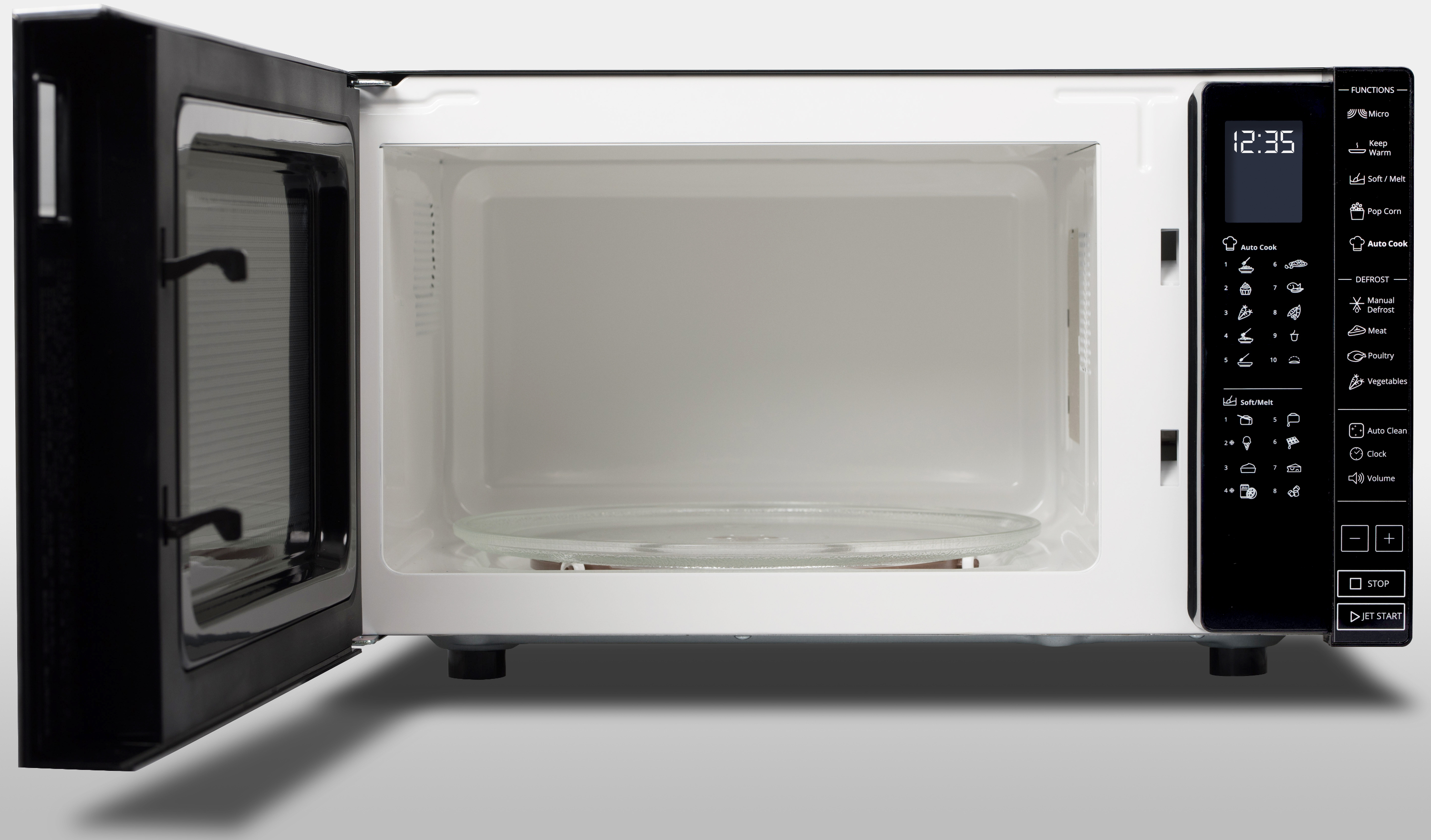 Open microwave oven with the door open. There is a glass plate inside.